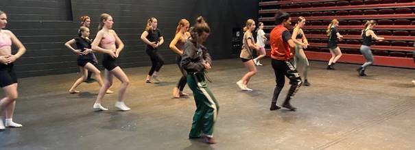 A group of people dancing

Description automatically generated with medium confidence