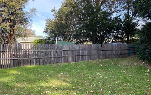 A fenced in yard with trees

Description automatically generated with low confidence
