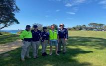 A group of people standing in a field

Description automatically generated with medium confidence