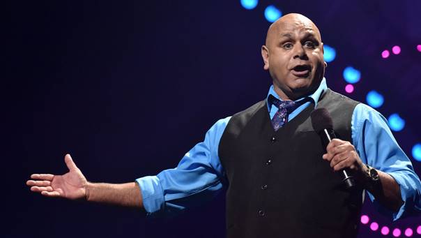 A person holding a microphone

Description automatically generated