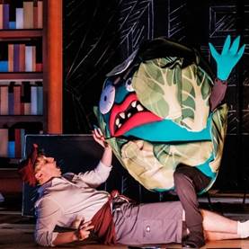A person lying on the floor with a cartoon character on his back

Description automatically generated