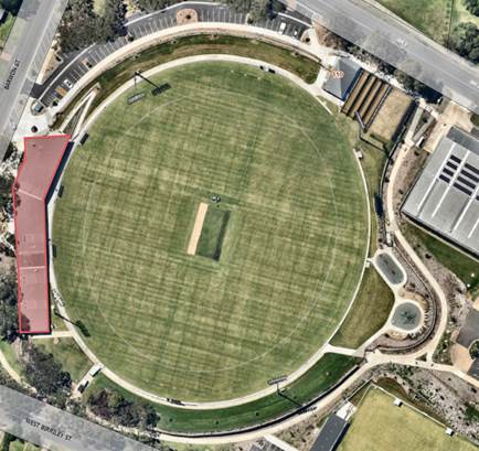 An aerial view of a circular green field

Description automatically generated