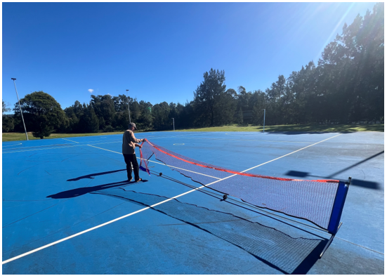 A person holding a net on a tennis court

AI-generated content may be incorrect.