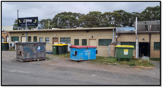 A group of garbage cans in front of a building

AI-generated content may be incorrect.
