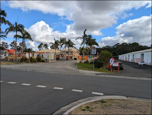 A street with buildings and trees

AI-generated content may be incorrect.