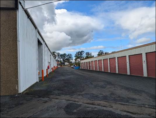 A road leading to a storage building

AI-generated content may be incorrect.