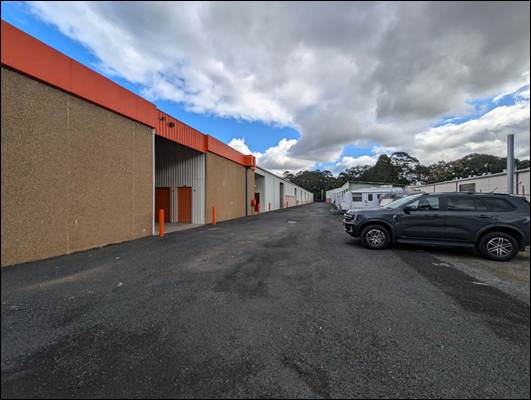 A parking lot with cars parked in front of a building

AI-generated content may be incorrect.