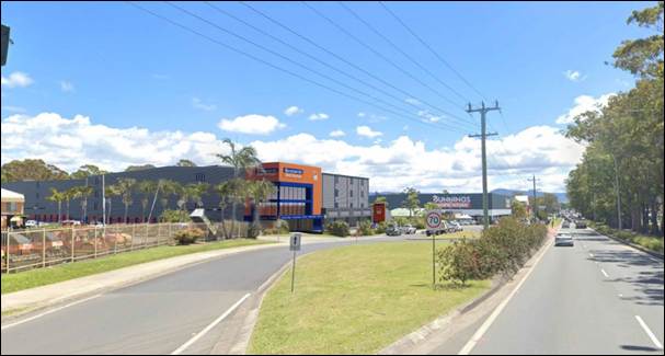 A road with power lines and a building

AI-generated content may be incorrect.