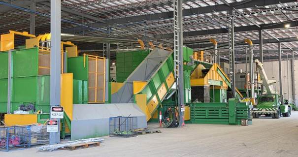 A large factory with green and yellow machines

AI-generated content may be incorrect.